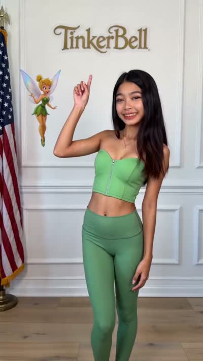 Dark-haired in a green crop top and matching leggings