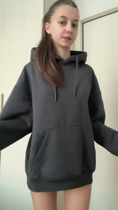 Brunette in an oversized grey hoodie