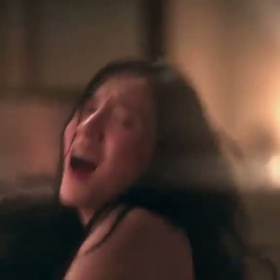 Close-up POV clip of a woman in low light