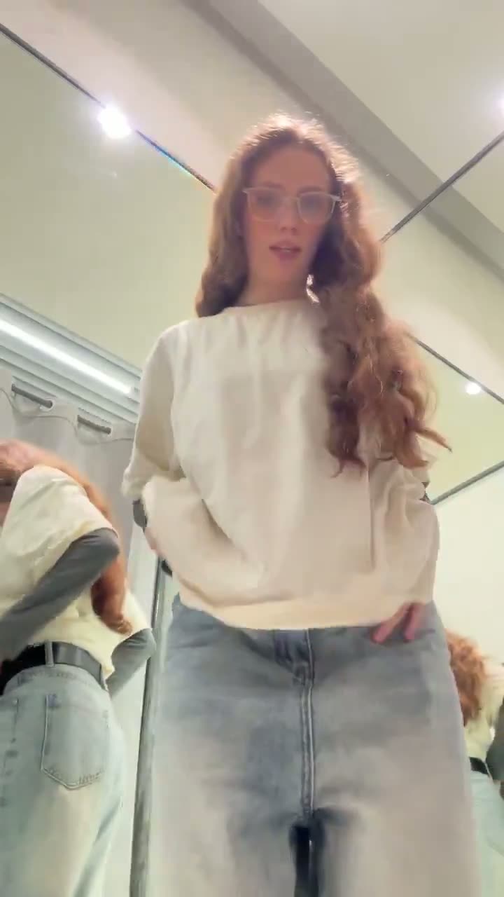 Brunette in a cream sweater and jeans