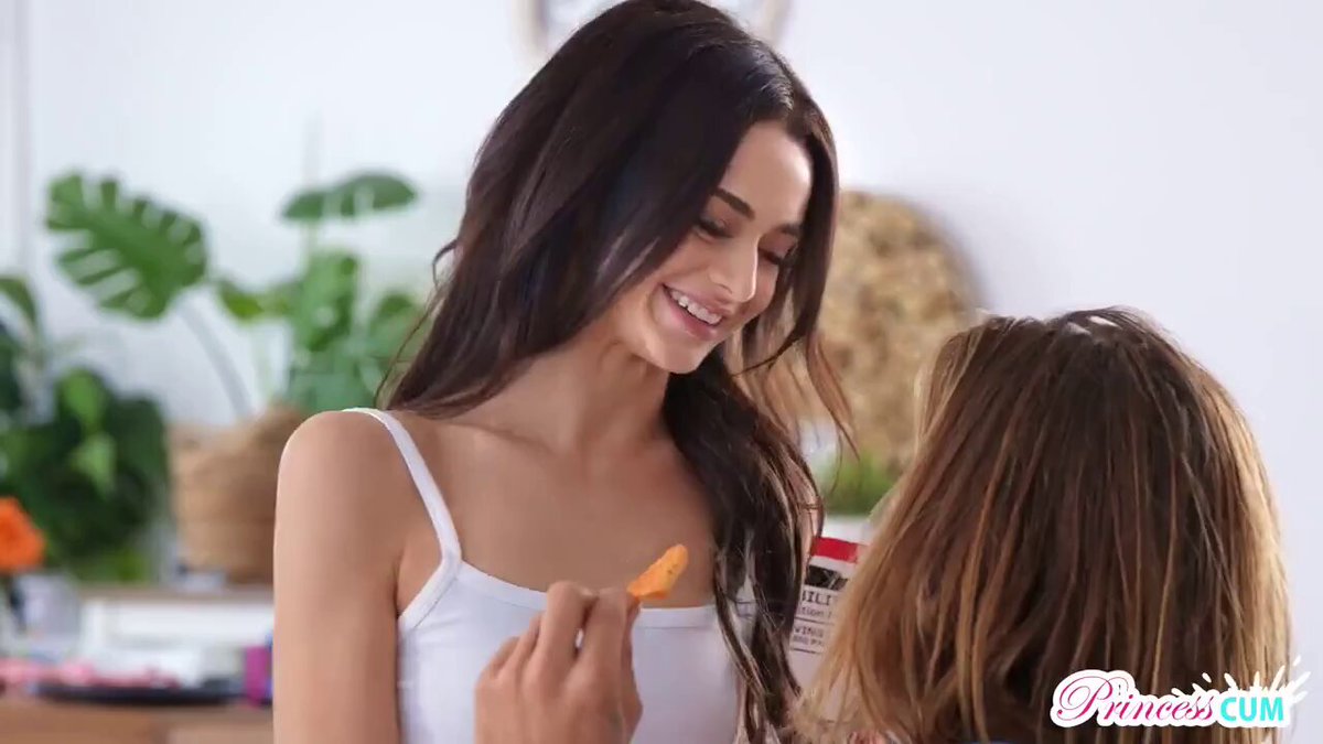 Brunette in a white tank top feeding a chip in the kitchen (@DesireZone27)