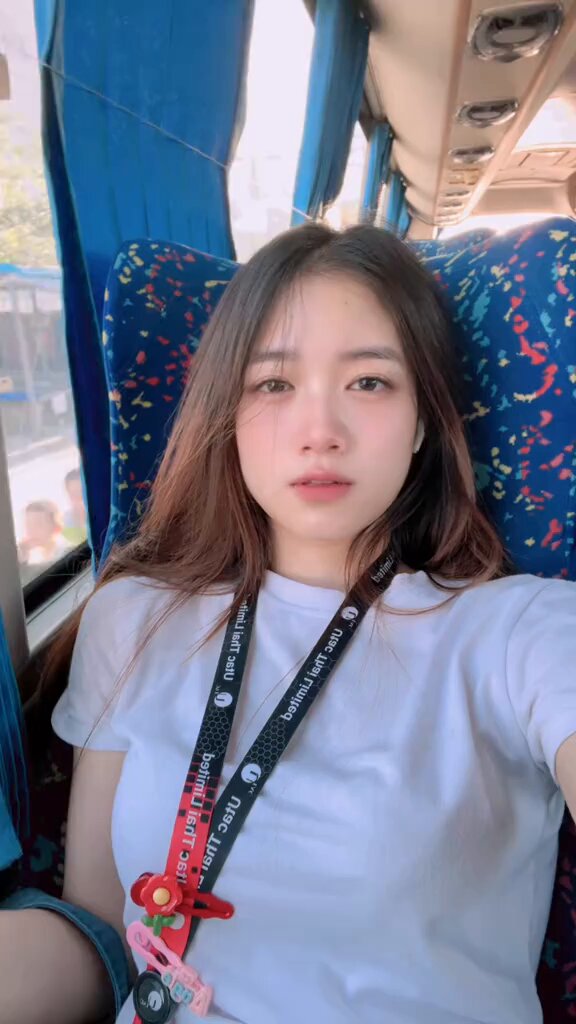 Brunette in a white tee on a bus