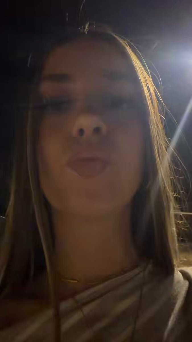 Brunette in a grey top in a nighttime close-up (@hiaratw)