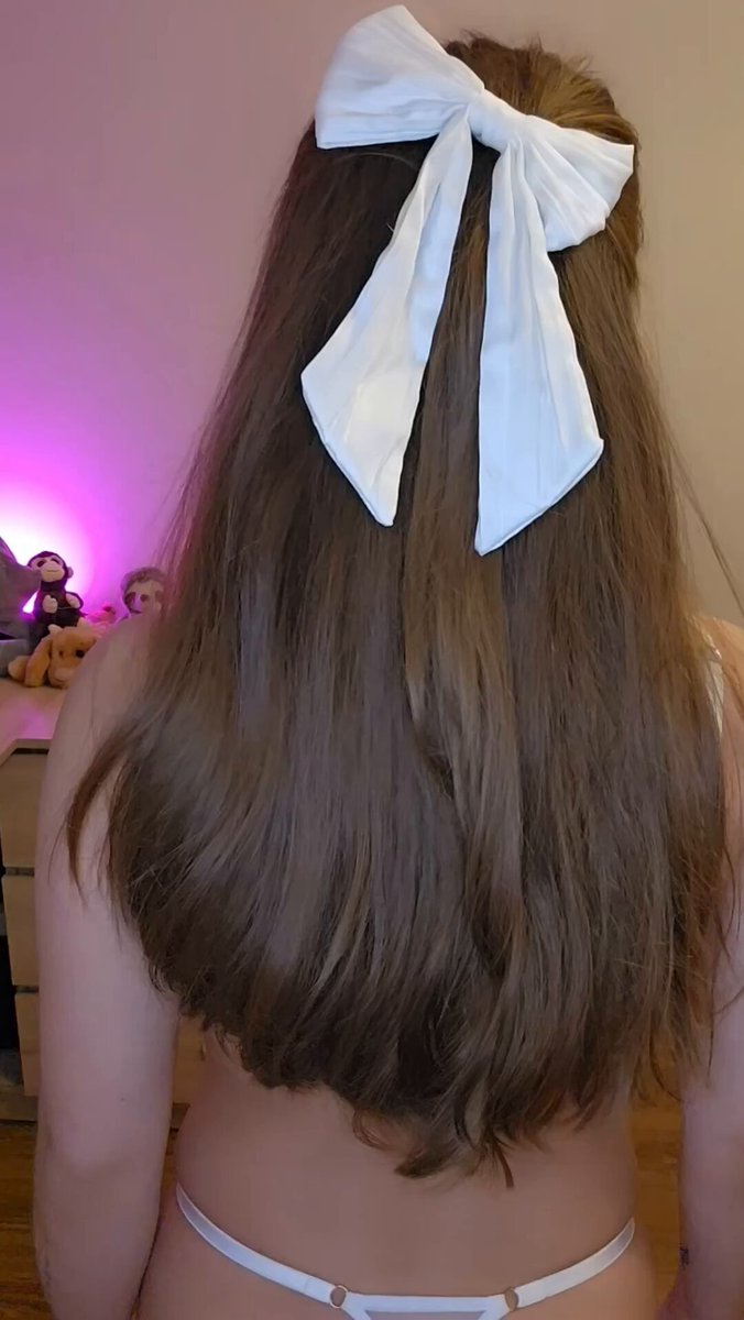 Brunette with a white bow in her hair, back to camera in a white thong (@mia_roossee)