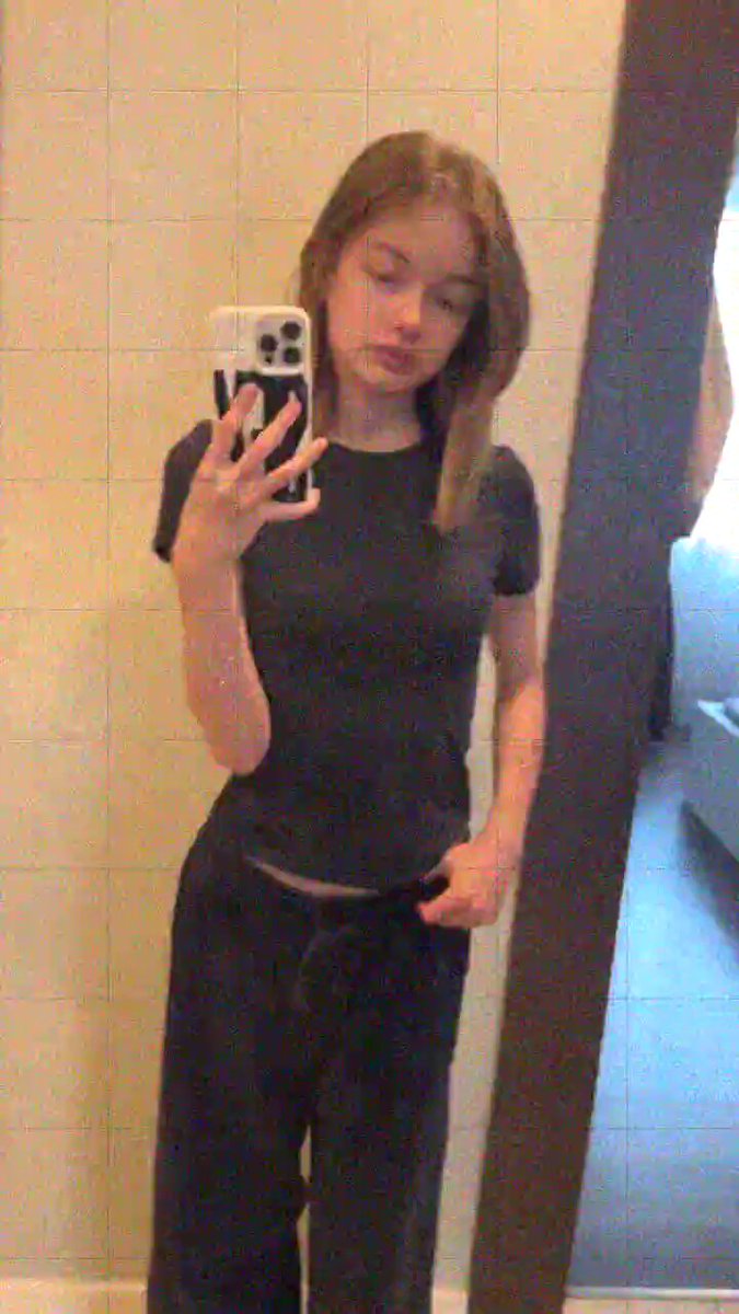 Brunette in a black tee taking a mirror selfie (@AbdulMa51824145)