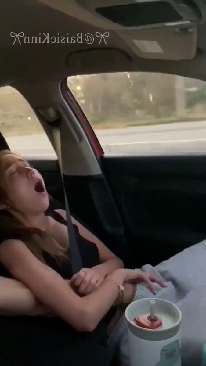 Blonde in a black top yawning in a car (@ShiPotterdcgy)