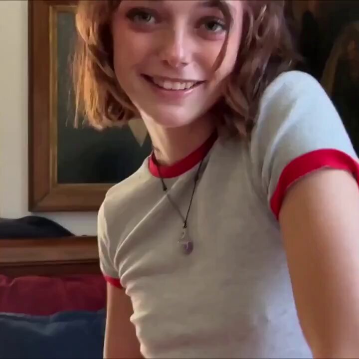 Brunette with short wavy hair in a white ringer tee (@djsaracox)