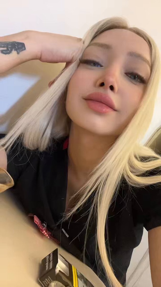 Blonde in a black collared top taking a selfie (@jstfrme22)