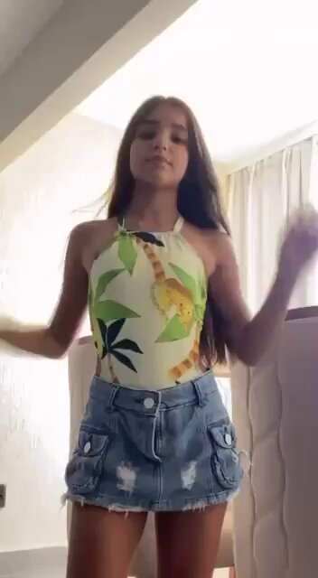 Brunette in a tropical print halter and denim cargo mini (@Bambikxj)