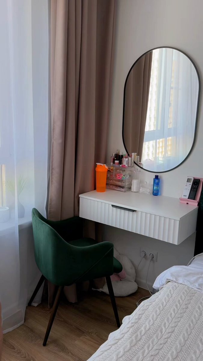 Bedroom vanity with a green chair and oval mirror (@VishalP3944)