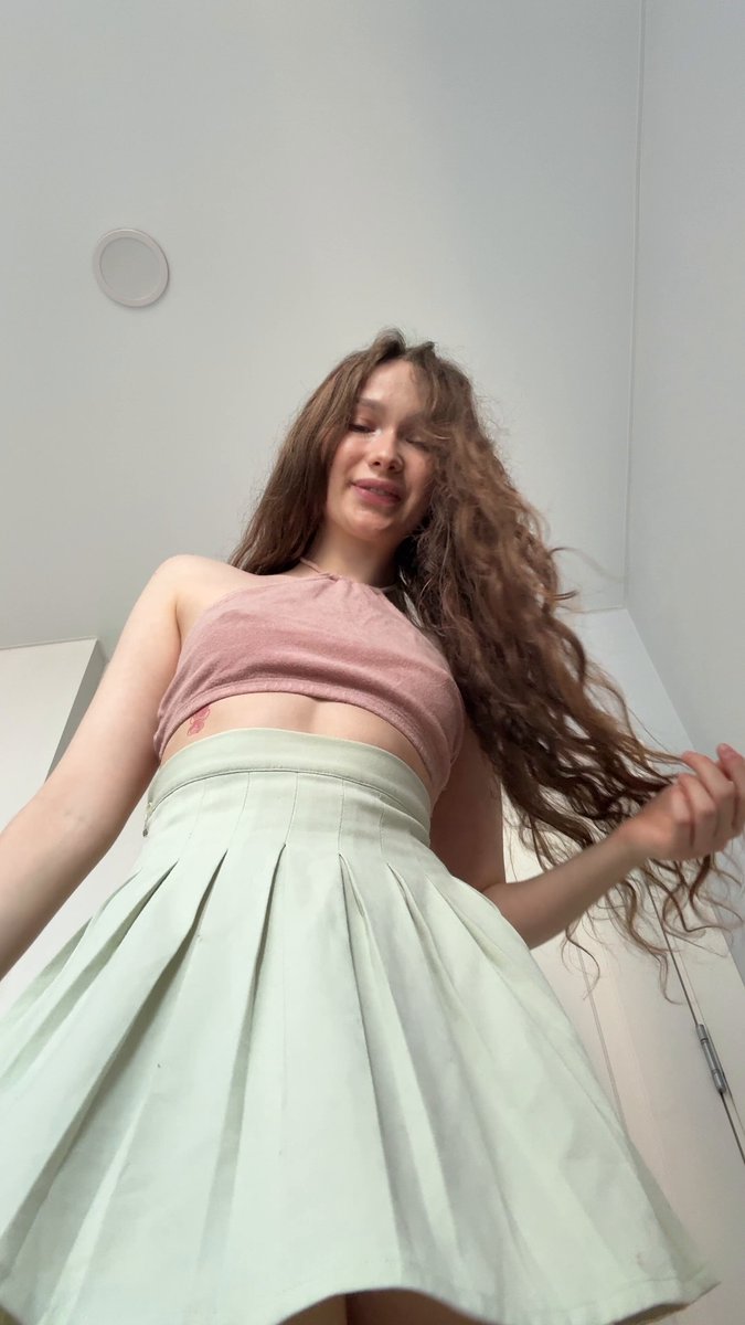 Brunette in a pink halter and mint pleated mini (@luzluzilay)