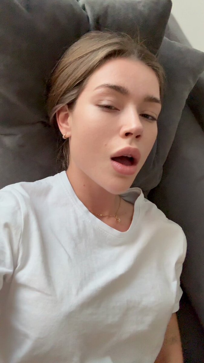 Brunette in a white t-shirt on a gray couch (@poooojamanh)
