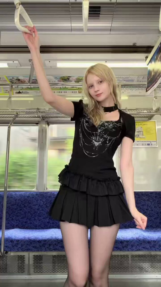 Blonde in a black graphic top and ruffled mini skirt on a train (@ArunBha89728675)