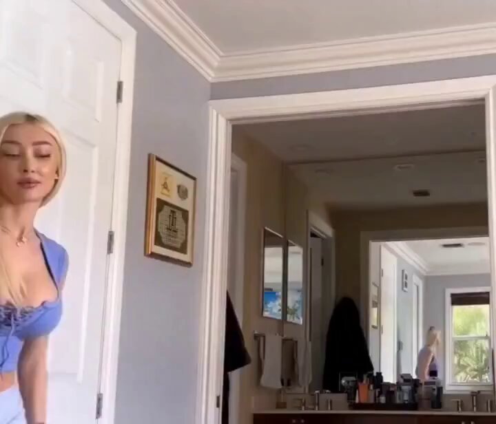 Blonde in a blue top in a bathroom hallway (@joselutovar)