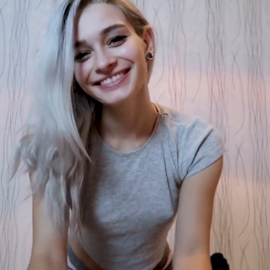Platinum blonde in a gray cropped tee with ear gauges (@magicalldeup)