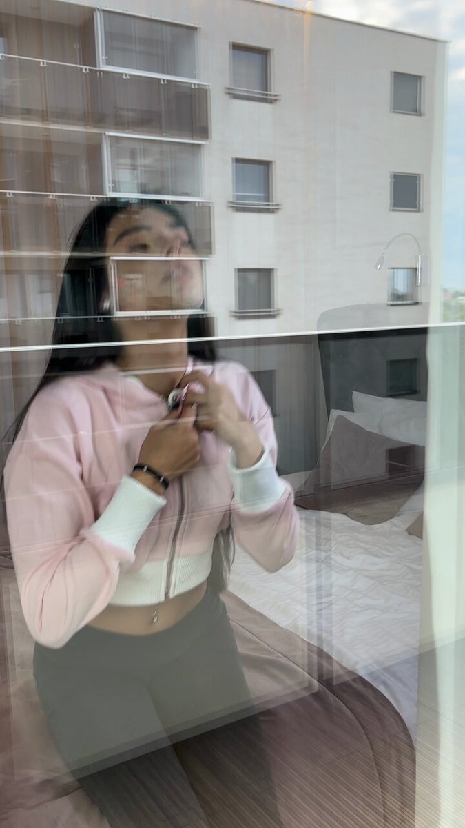 Brunette in a pink zip hoodie and black pants through a window (@VonBob81243)