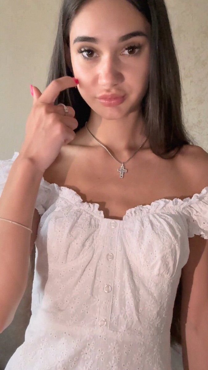 Brunette in a white eyelet off-shoulder top with a cross necklace (@maryfer1790)