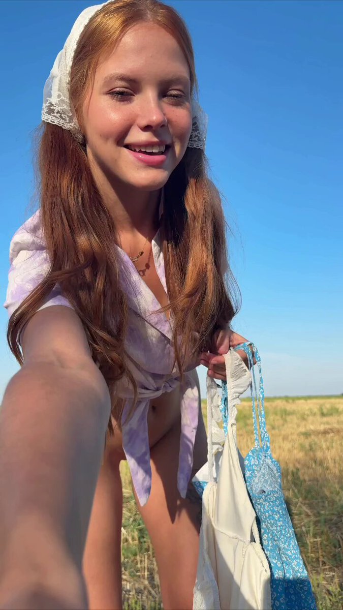 Redhead in a white lace headscarf and tied lavender blouse in a field (@canddyllady)