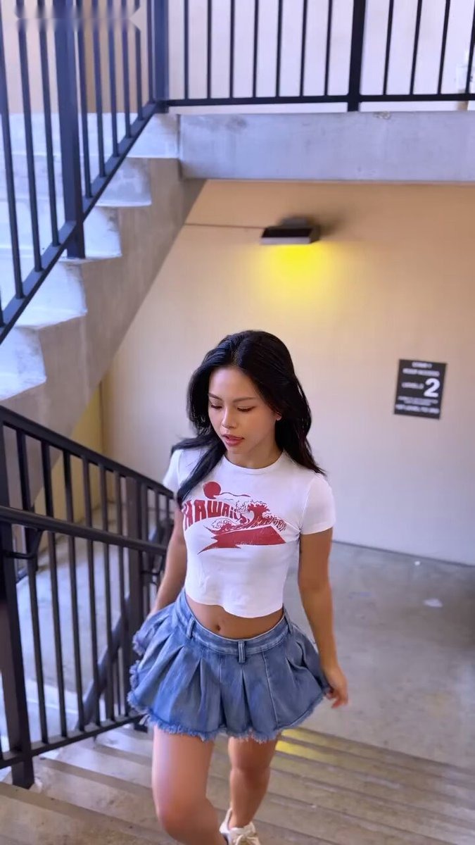 Brunette in a white Hawaii crop tee and a blue denim mini skirt on concrete stairs (@HannaMii_x)