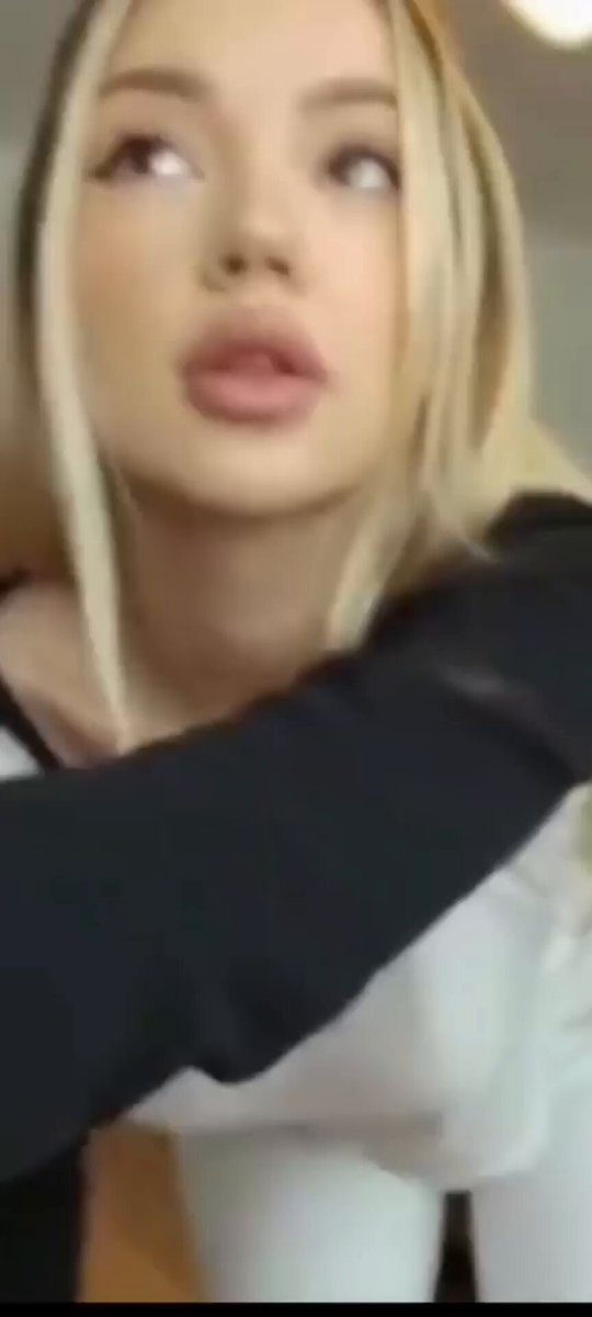 Blonde in a black-and-white long-sleeve looking up