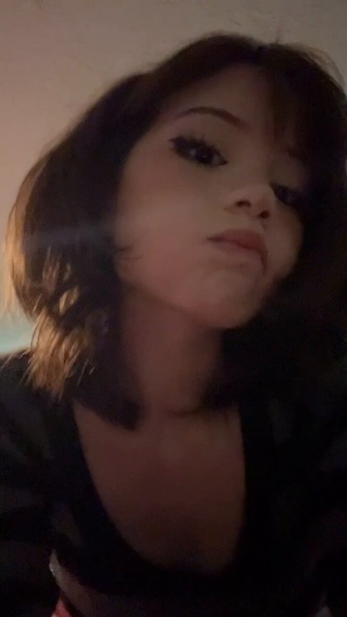 Brunette with a bob in a black low-cut top