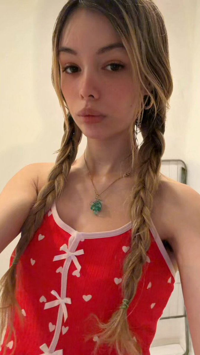 Brunette with pigtail braids in a red heart-print bow top and pink panties