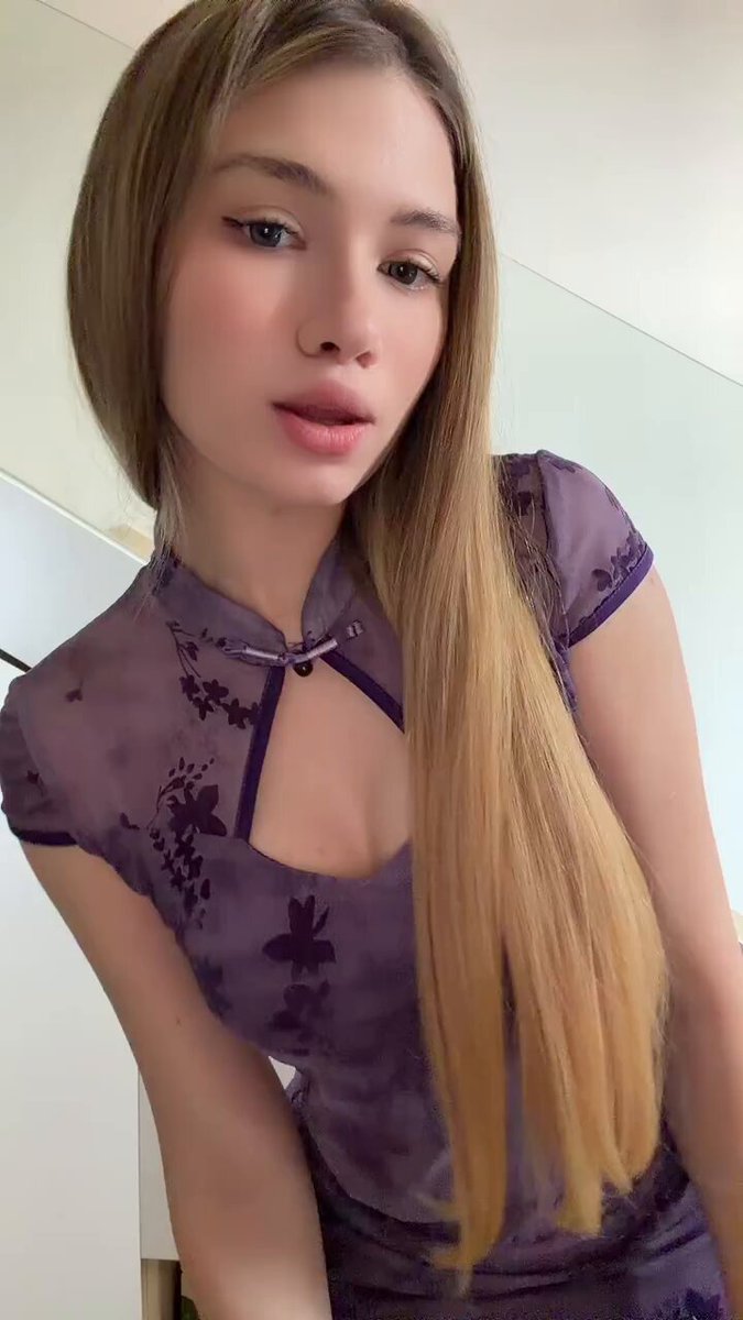 Blonde in a purple floral cheongsam with a keyhole neckline