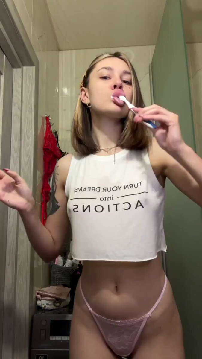 Blonde in a white crop tank and pink panties brushing her teeth (@irylove1)