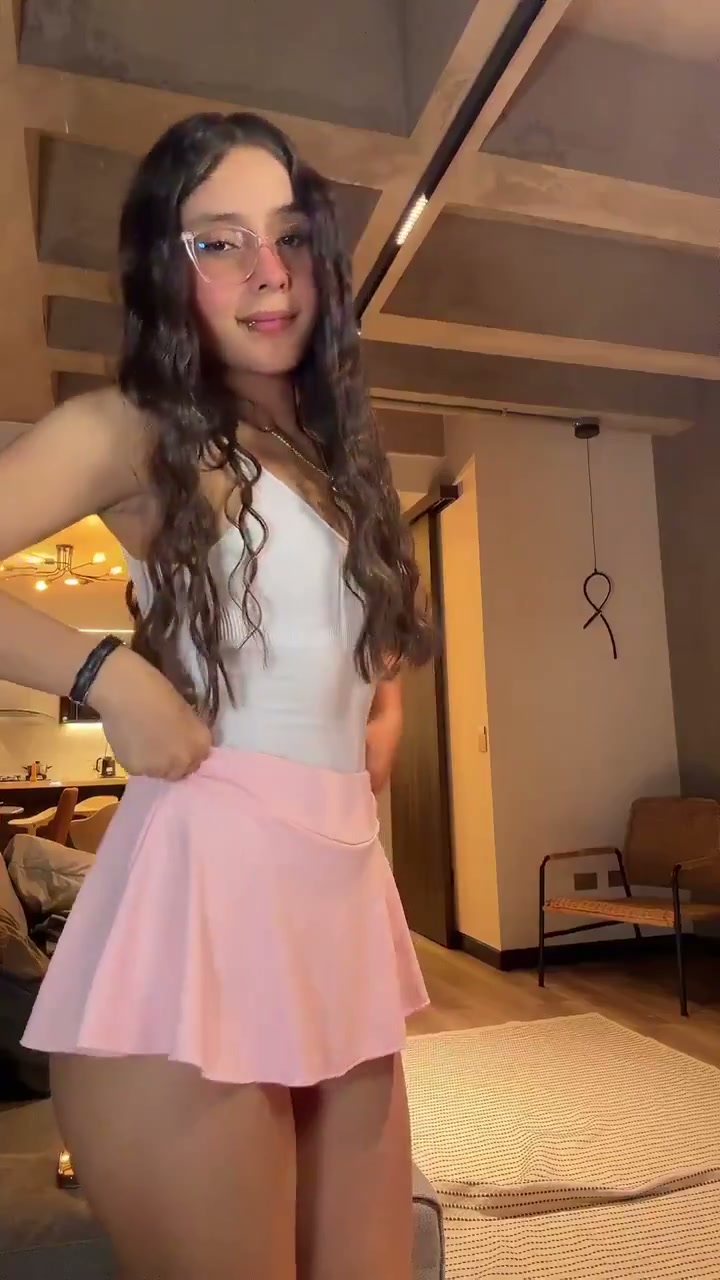 Brunette in glasses, a white top, and a pink skirt (@Bigbigbone88)