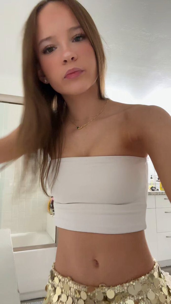 Brunette in a white tube top and gold skirt in a bathroom (@TopBops1go3)
