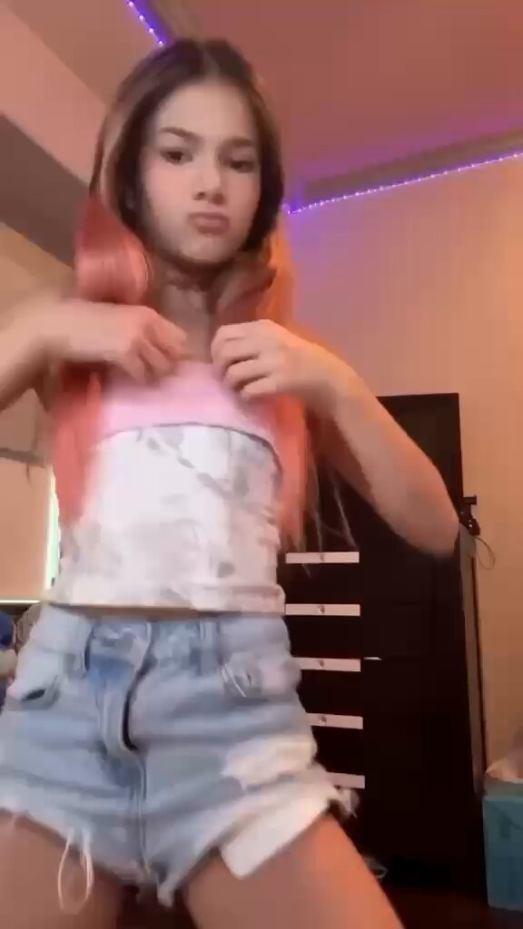 Blonde in a pink top and denim shorts by a window (@bestsellerve04)