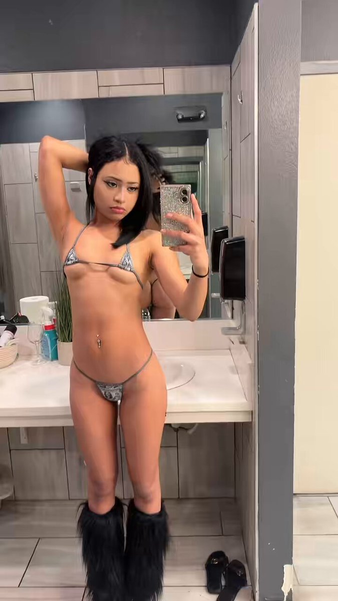 Brunette in a silver bikini and black fur boots by a bathroom sink (@pwiincessgabby)